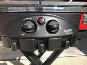 A close up of the controls on an electric grill