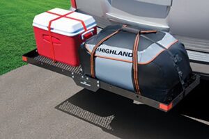 A cooler and luggage on the back of a vehicle.