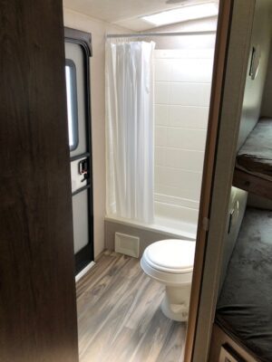 A bathroom with a toilet and shower in it