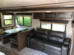 A couch and table in the living room of an rv.