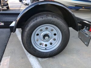 A close up of the tire on a trailer.
