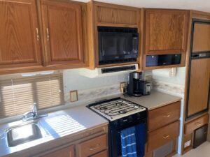 A small kitchen with a 2000 Itasca Spirit 31' and microwave.