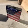 A suitcase with an american flag painted on it.
