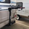 A white rv with two bikes attached to it.