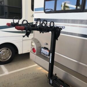 A bike rack is attached to the back of a bus.