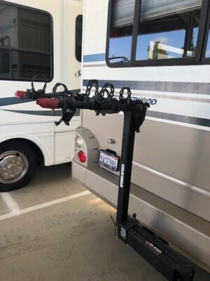 A bike rack is attached to the back of a bus.