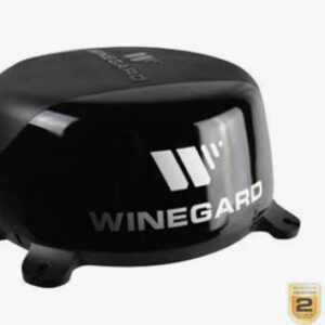 A black winegard antenna sitting on top of a table.