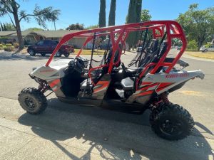 A 2017 Maverick Can-Am 4 person parked on a street.