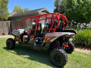 A 2017 Maverick Can-Am 4 person is parked in a yard.