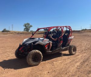 A 2017 Maverick Can-Am 4 person in the dirt.