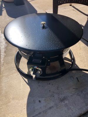 A Add Gas Fire Pit sitting on a patio.