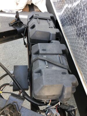 A close up of the back of a truck with many pieces of equipment.
