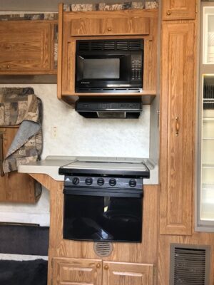 A stove and microwave in the kitchen of an rv.