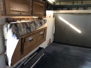 A kitchen with wood cabinets and a sink.