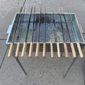 A Add Gas Fire Pit with several wooden sticks on it.