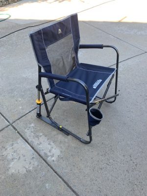 A blue Add Gas Fire Pit sitting on a sidewalk.