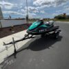 A jet ski is parked on the side of the road.