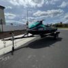 A jet ski is parked on the side of the road.