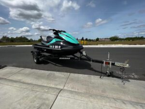 A jet ski is parked on the side of the road.