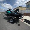 A jet ski is parked on the side of the road.