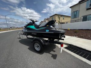 A jet ski is parked on the side of the road.