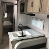 The interior of a 2021 Coachmen Freelander 30' Class C with a kitchen and sink.