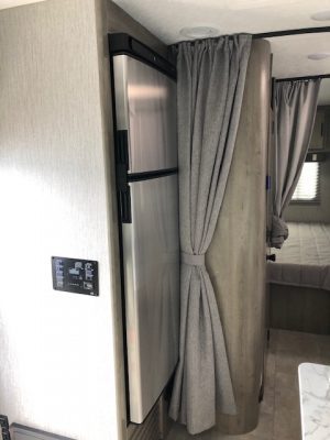 The interior of a 2021 Coachmen Freelander 30' Class C with a refrigerator and sink.