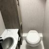 A small bathroom with a 2021 Coachmen Freelander 30' Class C toilet and sink.