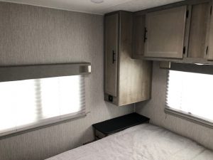 A 2021 Coachmen Freelander 30' Class C with a bed and a window.