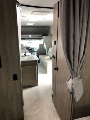 The interior of a 2021 Coachmen Freelander 30' Class C with a kitchen and living room.