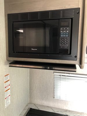 A 2021 Coachmen Freelander 30' Class C is in the kitchen of a small rv.