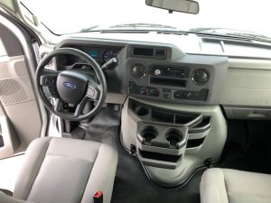 The interior of a 2021 Coachmen Freelander 30' Class C with a steering wheel and dashboard.