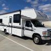 A 2021 Coachmen Freelander 30' Class C RV parked in a parking lot.