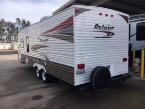 A 2011 Rainier Dutchman Bunk House 28' parked in a parking lot.