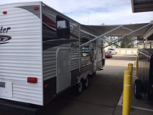 A 2011 Rainier Dutchman Bunk House 28' parked in a parking lot.