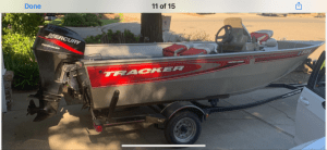 A picture of a 2003 Tracker Outboard Fishing Boat 16' with a motor attached to it.