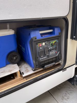 A generator is sitting in the back of a rv.