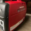A honda generator sitting in a garage.