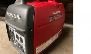 A honda generator sitting in a garage.