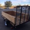 A trailer with a wooden side and metal sides.