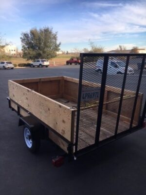 A trailer with a wooden side and metal sides.