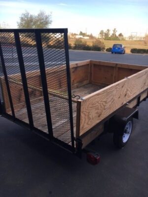 A trailer with a wooden side and metal frame.