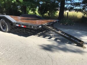 A trailer with wooden planks on it's back.