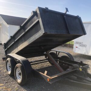 A dump trailer with the top open and the bottom half up.