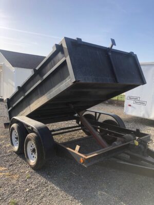 A dump trailer with the top open and the bottom half up.