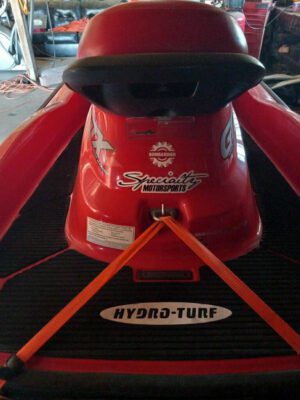 A red boat with a black hull and orange stripes.