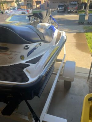 A jet ski parked on the side of a boat.