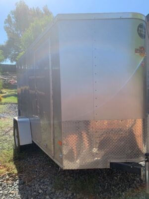 A trailer with the door open and the side of it.