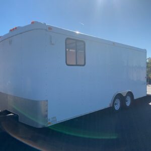 A white trailer with windows on the side.