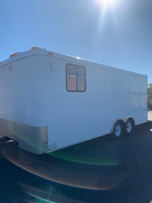 A white trailer with windows on the side.